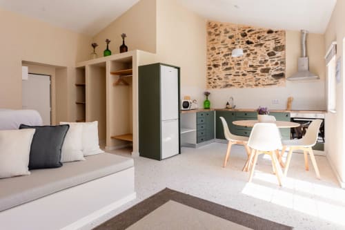 Modern studio apartment in Abrantes with kitchenette, dining area, and sofa in neutral tones