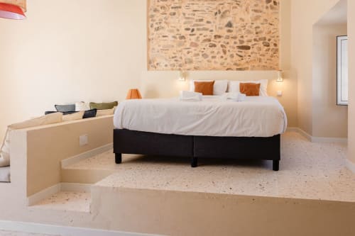 Modern bedroom at FC Housing Company in Abrantes with king bed, white linens, and terracotta accents