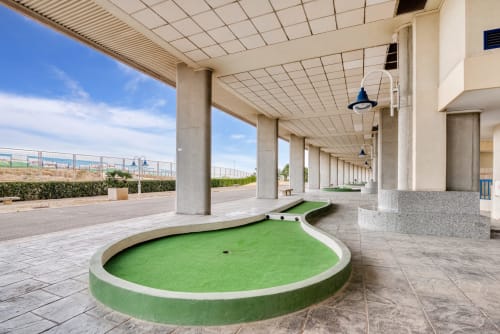 Mini golf course under covered terrace at Pataconablue beachfront apartment in Valencia with sea views