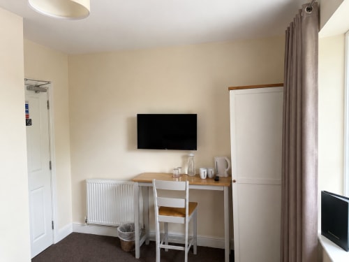 Double room at The Cornerhouse hotel in Somerset with desk, wall-mounted TV, radiator heating, and en-suite facilities