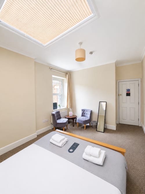 Spacious Family Suite bedroom at The Cornerhouse hotel in Somerset with skylight, seating area, and modern amenities
