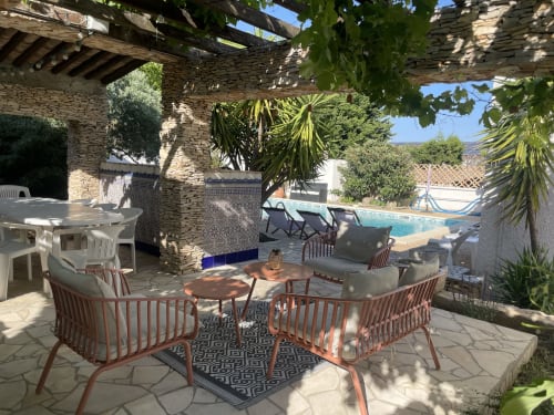 Terrasse cottage Minervois avec salon, vue piscine et pergola en pierre à La Closerie, La Redorte