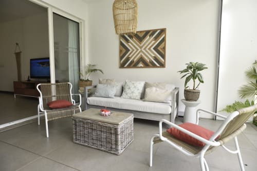 Modern garden view sitting area with white wicker chairs, gray sofa, and woven decor at O'Biches Apartment, Trou-aux-Biches