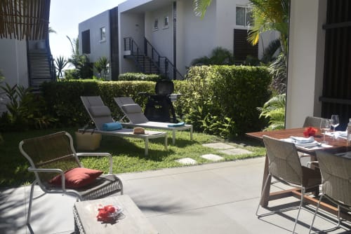 Garden view patio with lounge chairs, dining area, and landscaping at O'Biches Premium Holiday Apartment, Trou-aux-Biches