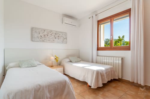 Luminoso dormitorio doble en Massa Properties en Artà con ventanas de madera, aire acondicionado y suelo de terracota