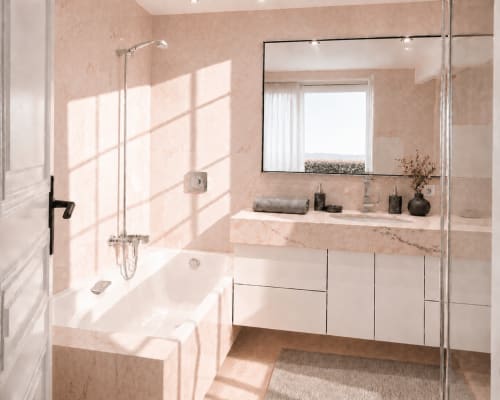 Luxury bathroom in Cannes apartment with marble finishes, soaking tub, rainfall shower, and sea view window