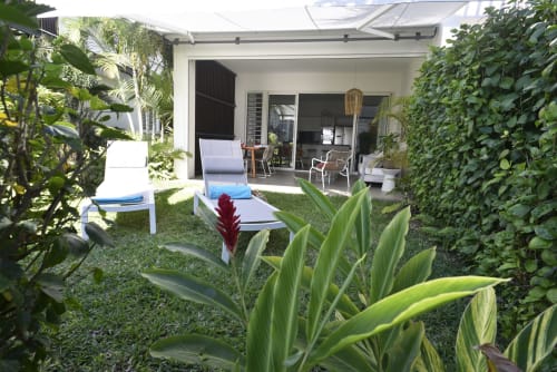 Tropical garden patio with lounge chairs at O'Biches Premium Holiday Apartment in Trou-aux-Biches, Mauritius