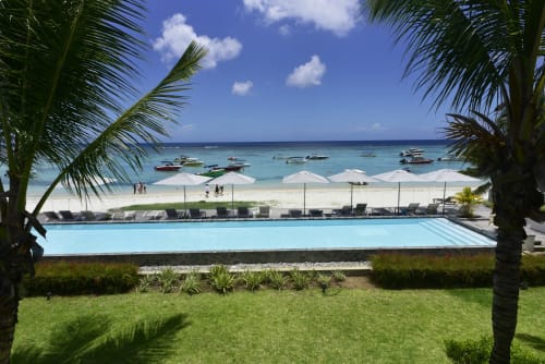 O'Biches Premium apartment pool overlooking Trou-aux-Biches beach with turquoise waters and moored boats