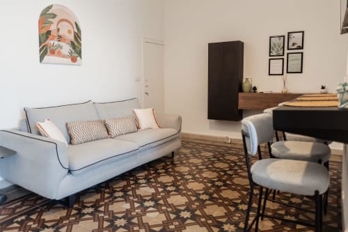 Camera Francesco nella B&B Casanova a Cefalù con divano color crema, arredamento moderno e vista sul cortile interno