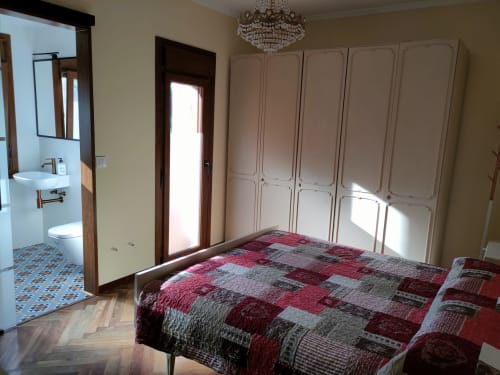 Spacious bedroom at Casa Pedro villa in Pantón with queen bed, built-in wardrobe, and en-suite bathroom