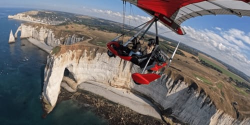 Hang gliding adventure over white cliffs near Clos Céleste in Étretat, Normandy