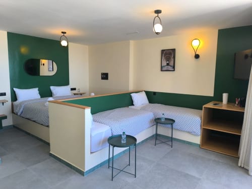 Modern apartment bedroom at SAMYAflat Tanger with twin beds, green accent wall, and contemporary lighting