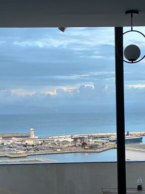 Balcony view of Tangier port with ships, sea, and cloudy sky from SAMYAflat apartment