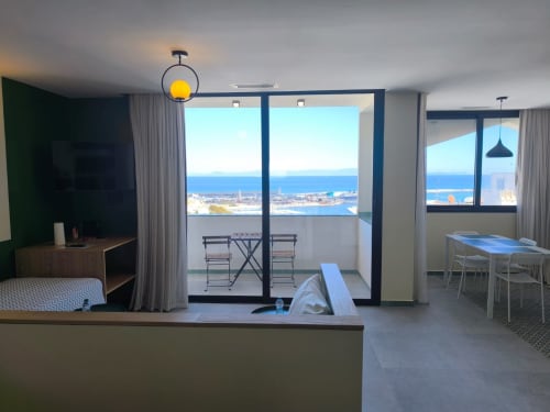 Modern Tanger apartment with sea view balcony, dining area, and bedroom at SAMYAflat
