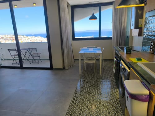 Modern Tangier apartment with sea views, dining area, kitchenette, and ocean-facing balcony