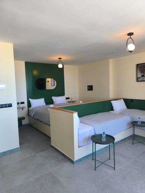 Modern apartment bedroom at SAMYAflat Tangier with twin beds, green headboards, pendant lights, and contemporary furnishings