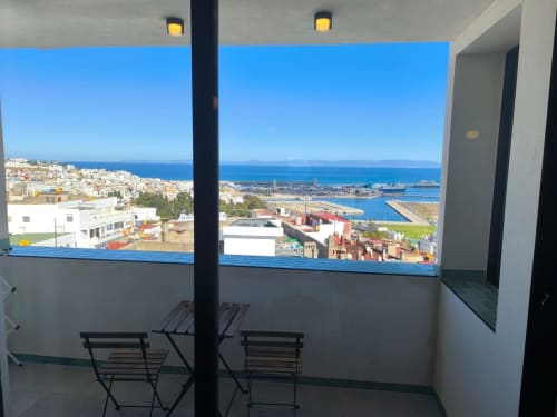 Balcony view from SAMYAflat in Tangier showing Mediterranean Sea, port, and white city architecture below