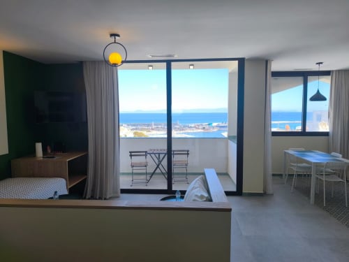 Modern apartment at SAMYAflat Tangier with ocean views, dining area, balcony, and contemporary furnishings