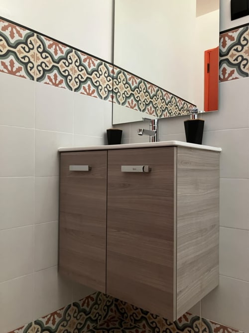 Modern bathroom vanity with dark wood cabinets and ornate tile border in YaYaCaSa Ocre apartment at SAMYAflat, Tangier