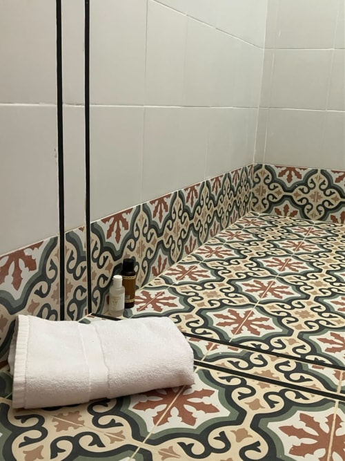 Modern bathroom in YaYaCaSa Ocre apartment at SAMYAflat, Tangier, featuring decorative patterned floor tiles and white subway