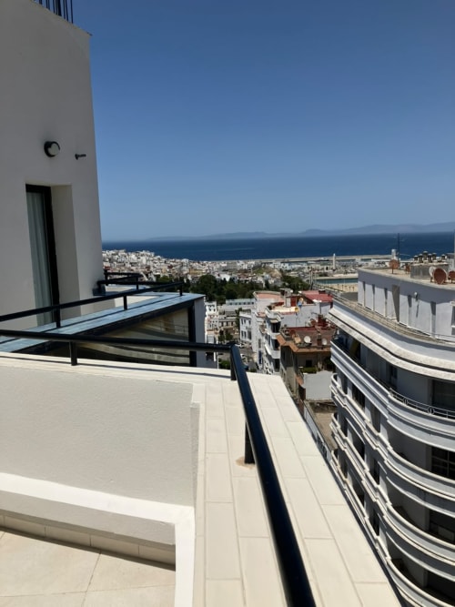 Balcony view from YaYaCaSa Ocre apartment at SAMYAflat in Tangier overlooking the Mediterranean Sea and coastal city
