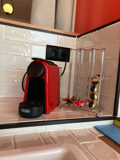 Red DeLonghi coffee maker with capsule storage in YaYaCaSa Ocre apartment at SAMYAflat, Tangier