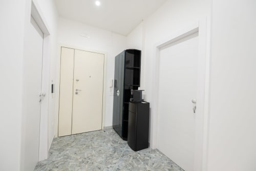 Corridoio moderno della camera Francy 3 all'hotel Newhouse di Bari, con porte bianche e arredamento nero