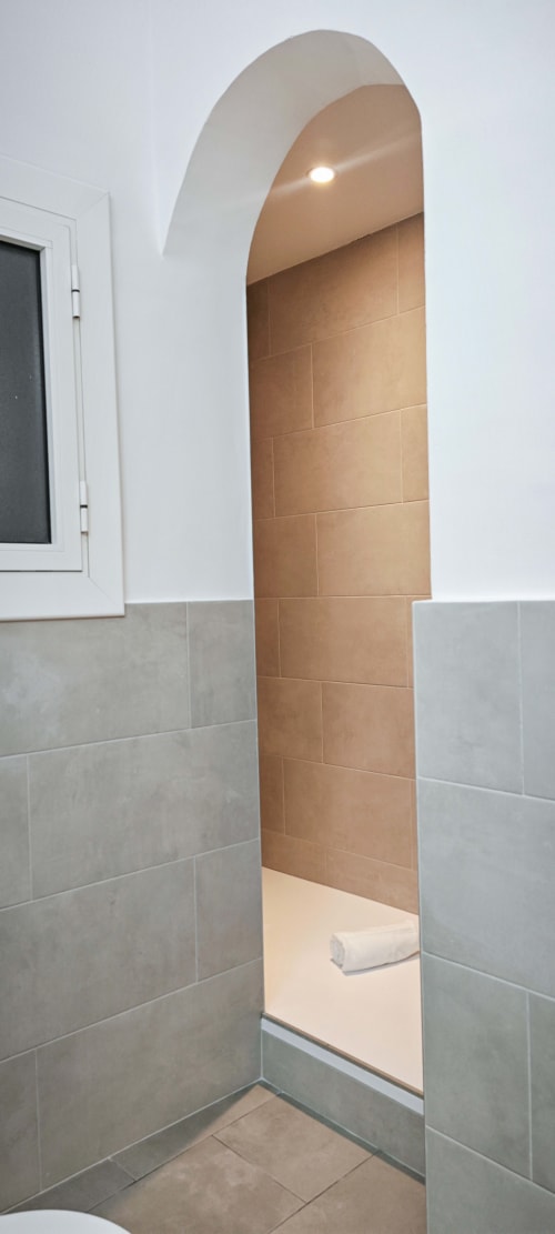 Arco de baño moderno con azulejos de terracota en apartamento de Barcelona, hotel BCNMADflats
