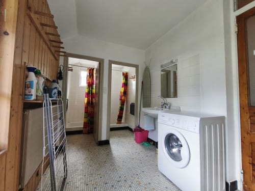 Bagno con lavatrice bianca e lavabo nello Chalet Coste Belle, Ceillac