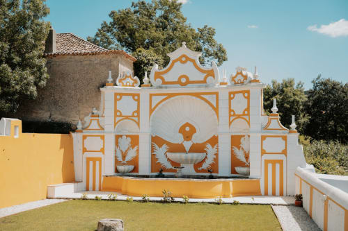 Ornate orange and white chapel entrance at Casa de Campo da Quinta da Pegada, a Portuguese countryside guesthouse in Óbidos.