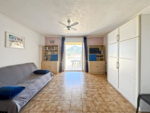 Studio à L'Île-Rousse avec vue montagne, canapé, mobilier bois, ventilateur et accès terrasse