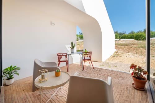 Modern suite terrace at Monte das Açoteias with lounge seating, dining area, and countryside views in Tavira, Portugal