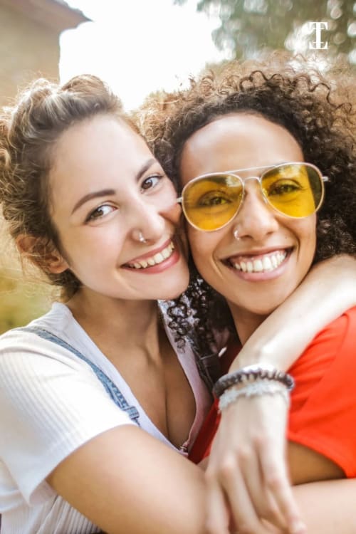 Deux femmes souriantes profitant d'un moment en plein air à l'hôtel Le Paradis Des Logis à Pierrefitte-sur-Seine