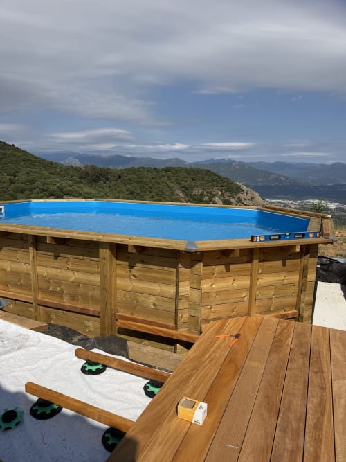 Piscine hors-sol en bois avec liner bleu surplombant les montagnes au Petit Coin de Paradis, Alata Corse