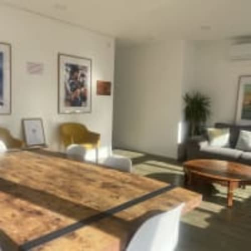 Vila Alexandra hostel studio in Costa da Caparica with wooden flooring, seating area, wall art, and modern furnishings
