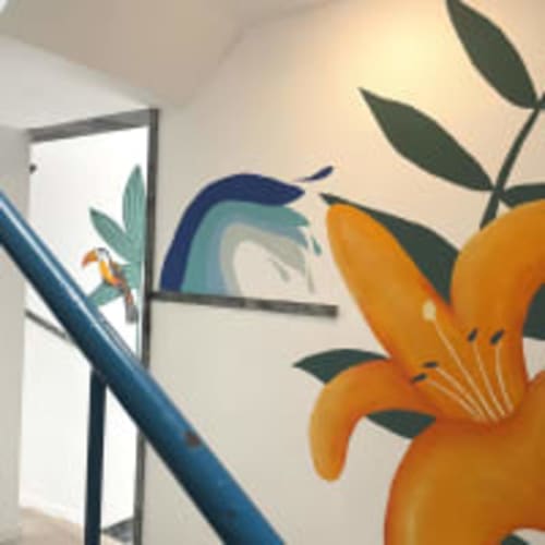 Modern studio room at Vila Alexandra hostel in Costa da Caparica with orange flowers, window view, and contemporary decor