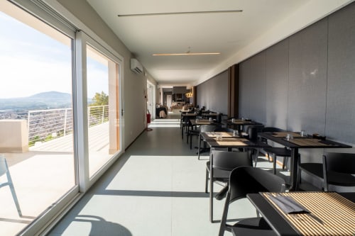 Modern hotel corridor with sea view balcony at Hotel Belvedere Resort, Castellammare del Golfo, featuring dining area and