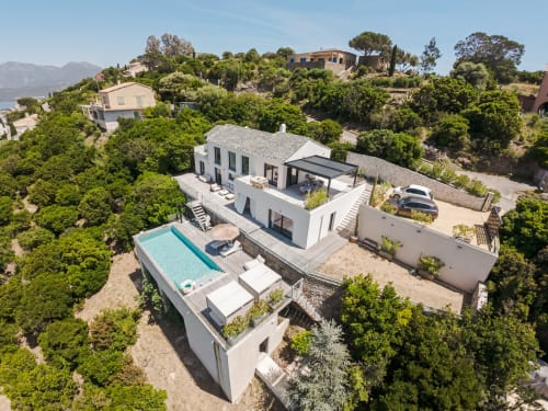 Villa Roya Saint-Florent: modern white villa with pool, sea view, terrace, and hillside setting