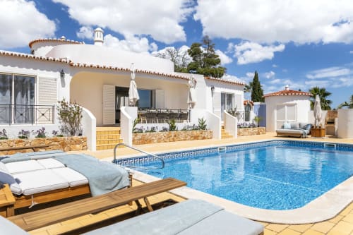 Villa Colina pool view in Carvoeiro with sunbeds, private swimming pool, and white Mediterranean-style villa