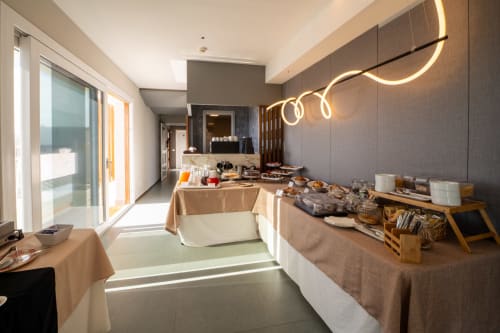 Hotel Belvedere Resort Deluxe room with sea view, featuring modern neon lighting, glass doors opening to balcony, and elegant