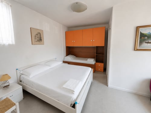 Appartamento Timavo con 2 camere, letti singoli, arredamenti moderni e mobili arancioni presso l'hotel Anthea, Lignano Sabbiadoro
