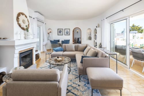 Modern Lagoa vacation rental living room with beige sectional, fireplace, and ocean views at MarVillas Rentals