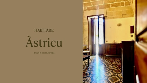 Àstricu room at HABITARE Lecce with yellow walls, decorative floor tiles, and wooden furnishings, Salento accommodation