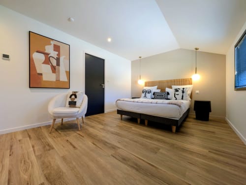 Chambre moderne à La Clairière aux Chênes à Treillières avec lit queen-size, luminaires suspendus, parquet et design contemporain