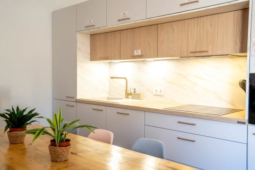 Cuisine moderne avec meubles en bois naturel, dosseret en marbre et coin repas du luxe gîte Le Mas De La Clé D'Or à Puget