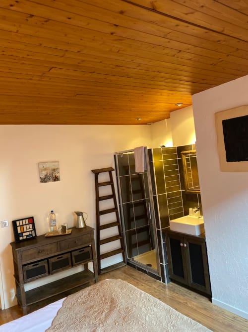Maupassant apartment bedroom at La Jument Verte B&B in Southern France with wooden ceiling, wooden furniture, and ensuite