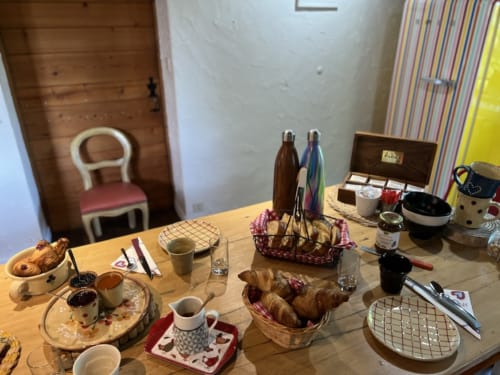 Breakfast table at La Jument Verte B&B in Southern France with pastries, coffee, and fresh croissants