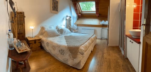 Ch. Lamartine apartment at La Jument Verte B&B in Southern France features a sloped ceiling bedroom with wooden floors and