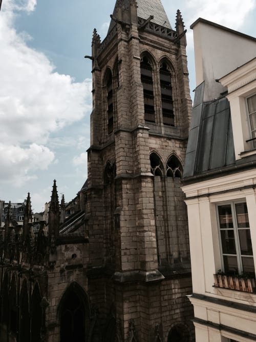 Gothic church tower with stone architecture adjacent to Cocoon Gallery Paris boutique hotel in the city center