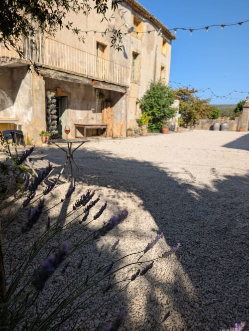 Lavender garden courtyard at Domaine de Pelican in Gignac with stone terrace and rustic French villa